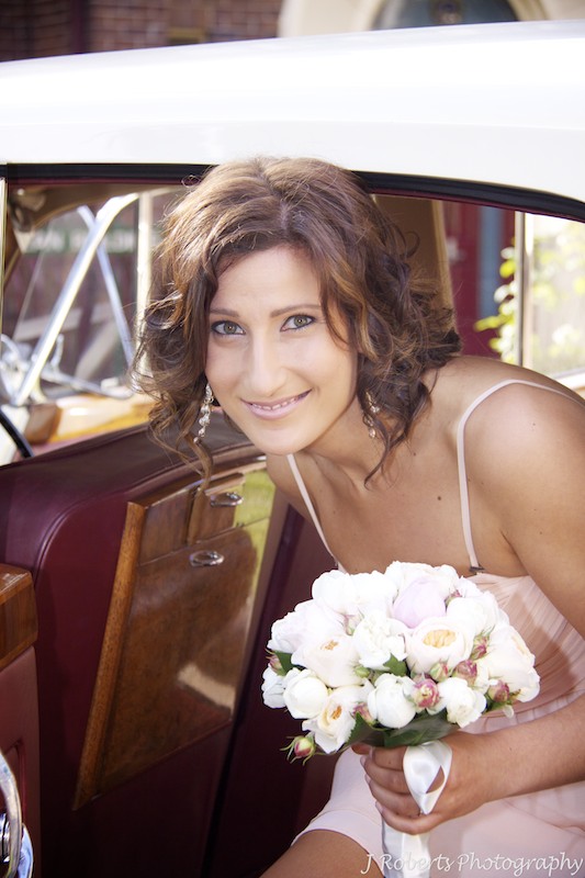 Brides sister a bridesmaid getting out of the cars at the church - wedding photography sydney